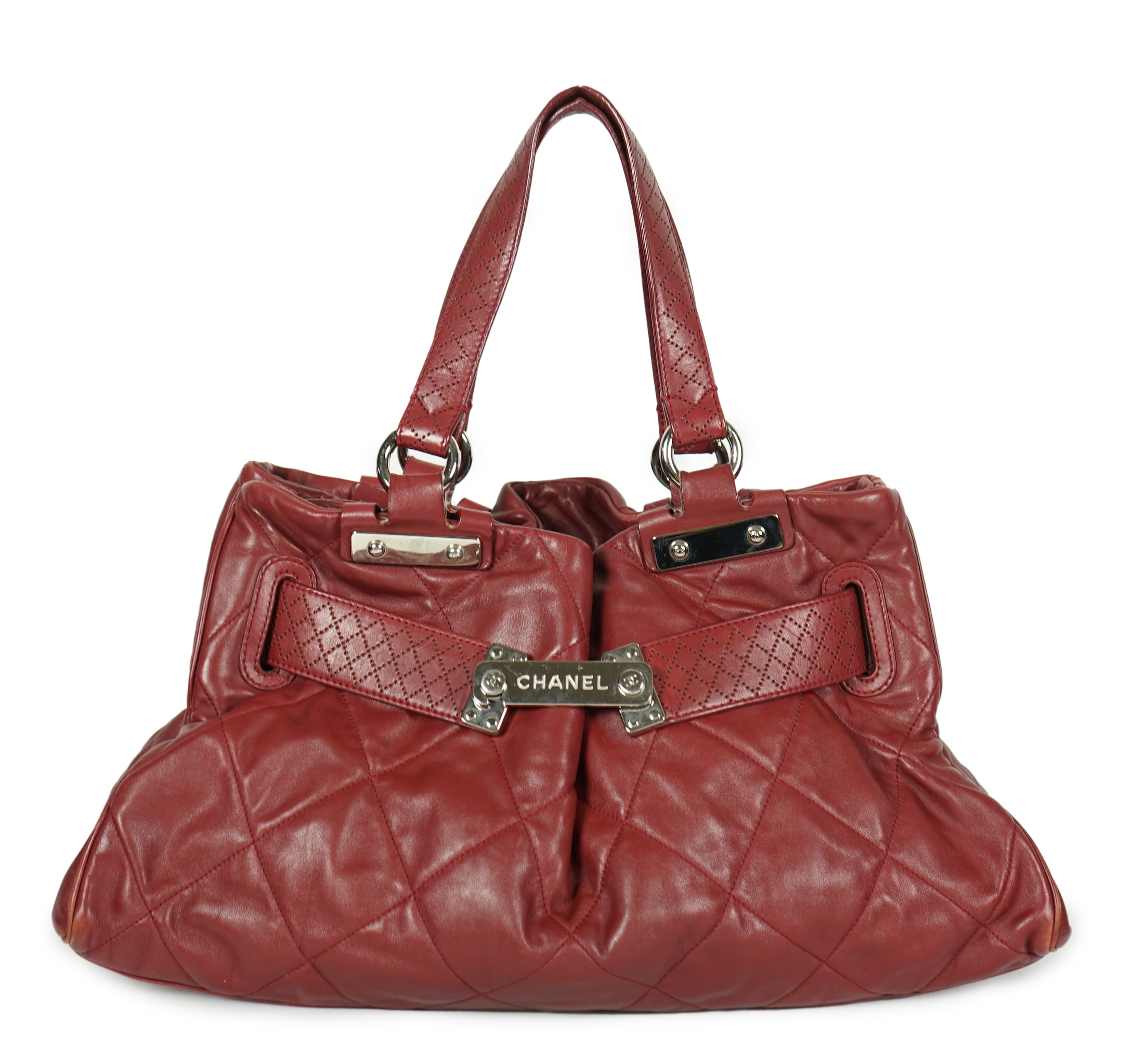 A Chanel burgundy leather buckled handle bag, with dust bag, width 45cm, height: 24.5cm, height overall 44cm, depth 16.5cm, Please note this lot attracts an additional import tax of 20% on the hammer price